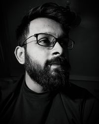 Portrait of young man wearing eyeglasses at home
