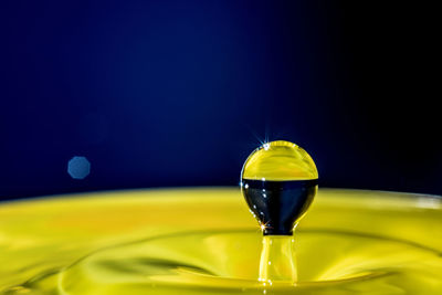 Close-up of water drops on glass against black background