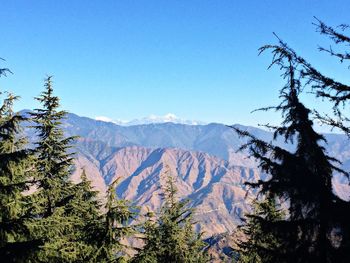 Scenic view of mountains against clear blue sky