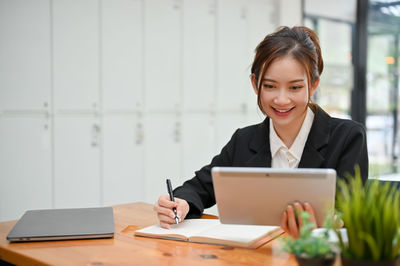 Businesswoman using laptop at office