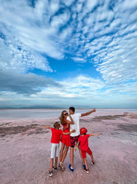 Family on a pink salt lake in the island of coche in the caribbean in venezuela