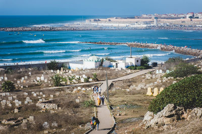 High angle view of people by sea against clear sky