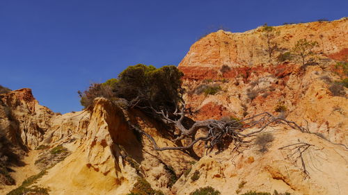 Rock formations on mountain against clear sky in portugal,  algarve 