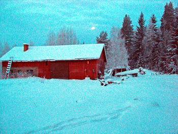 Snow covered land against blue sky