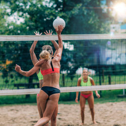 Beach volleyball players at the net