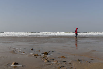 Scenic view of beach against clear sky