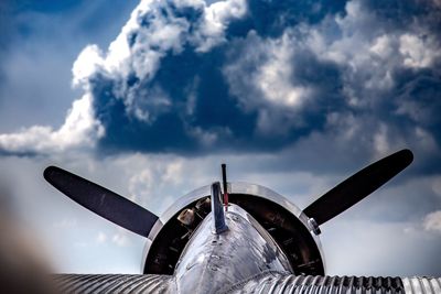 Low angle view of airplane flying against sky