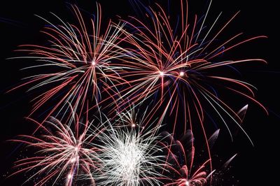 Low angle view of firework display at night