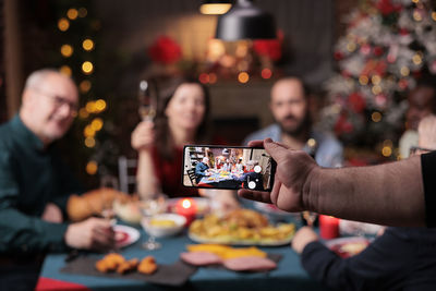 Cropped hands of woman using smart phone