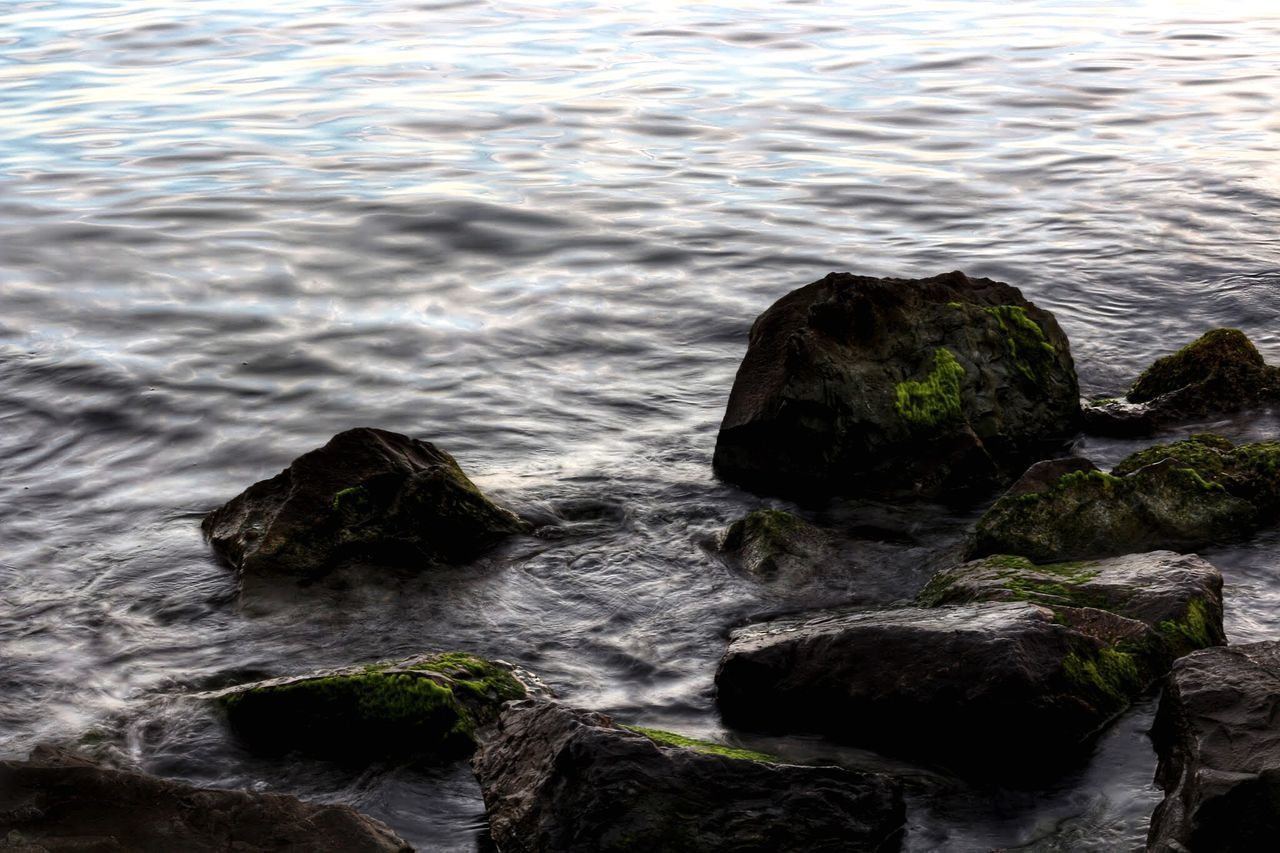 HIGH ANGLE VIEW OF ROCKS ON BEACH