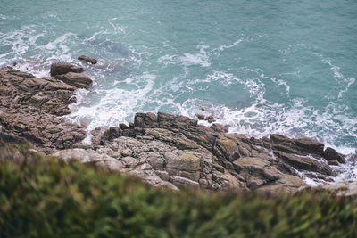 High angle view of rocks in sea