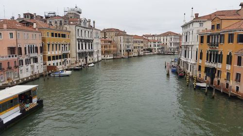 Boats in river with city in background