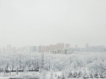 Buildings in city against sky during winter