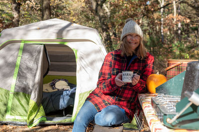 Smiling woman sitting outdoors