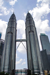 Low angle view of buildings against cloudy sky