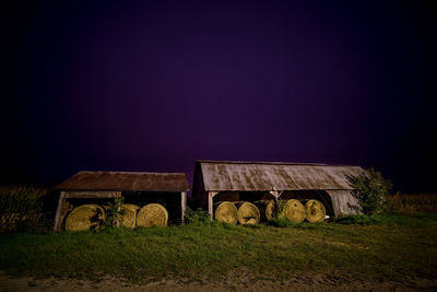 Built structure on field against clear sky at night