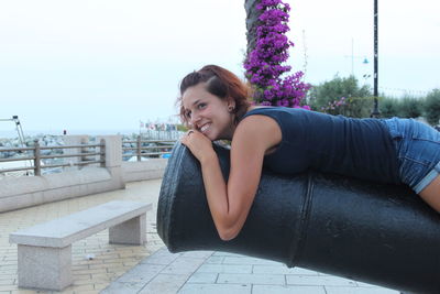 Portrait of smiling young woman sitting outdoors