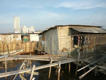 View of abandoned building in city against sky