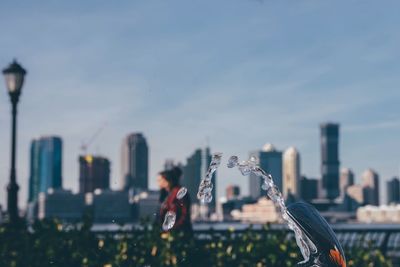 Close-up of modern cityscape against sky