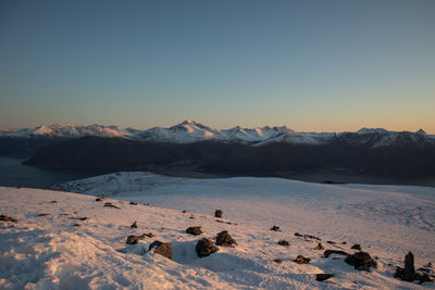 Scenic view of snowcapped mountains against clear sky