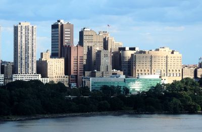 Buildings in city against blue sky