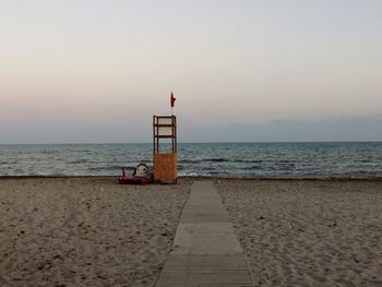 Lifeguard hut on beach against sky