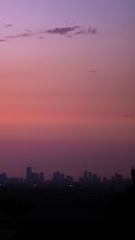 Silhouette buildings against sky during sunset