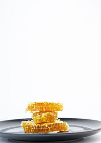 Close-up of cake on plate against white background