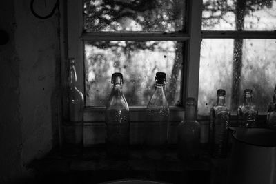 Close-up of bottles on window