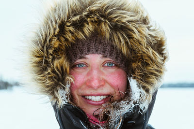 Portrait of smiling young woman in snow