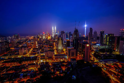 High angle view of illuminated cityscape against sky at night