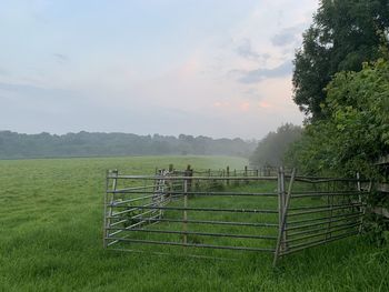 Fence on field against sky