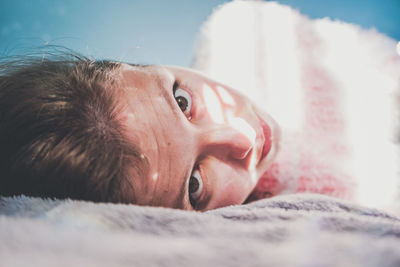 Portrait of man lying down on bed