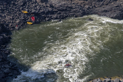 High angle view of people rafting in river