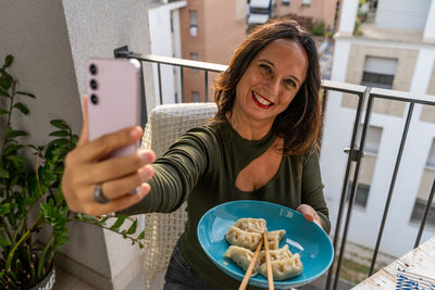 Portrait of young woman using mobile phone