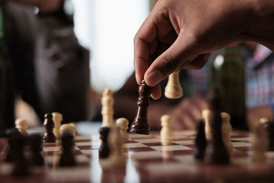 Cropped hand playing chess