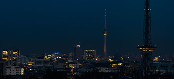 Aerial view of city lit up at night