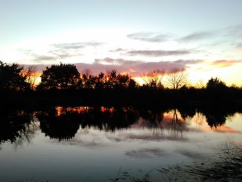 Scenic view of lake at sunset