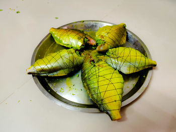 High angle view of yellow fruit on white background