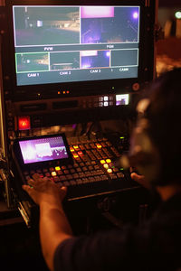 Rear view of man working at music concert