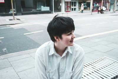 Portrait of young man on street in city