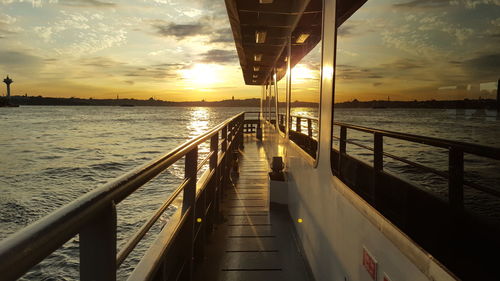 Pier over sea against sky during sunset