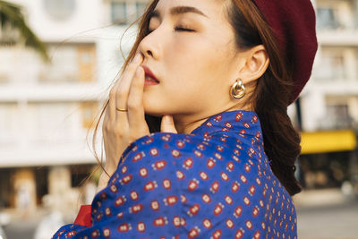 Close-up portrait of young woman looking away