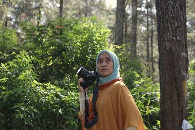 Young woman photographing through camera