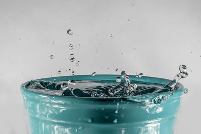 Close-up of water splashing against white background