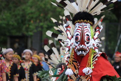 People in traditional clothing on street during festival