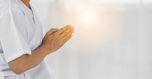 Midsection of woman holding umbrella