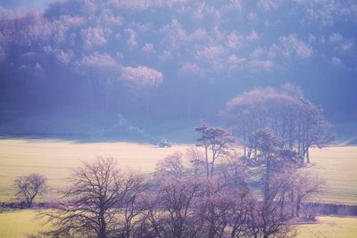 Scenic view of snow covered land against sky