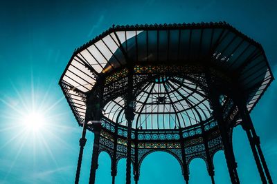 Low angle view of illuminated building against blue sky