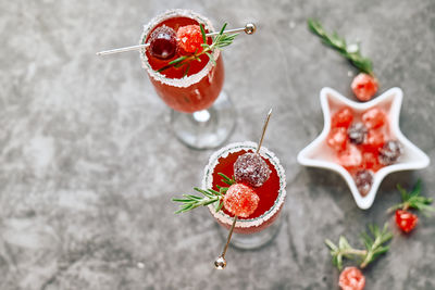 Christmas mimosa punch or cranberry margarita cocktail with orange liqueur and champagne.